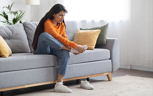 person holding their foot in discomfort