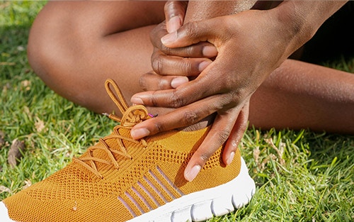 a person experiencing ankle pain