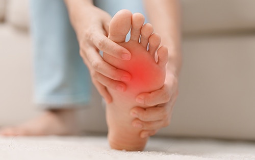 a person experiencing pain in ball of foot